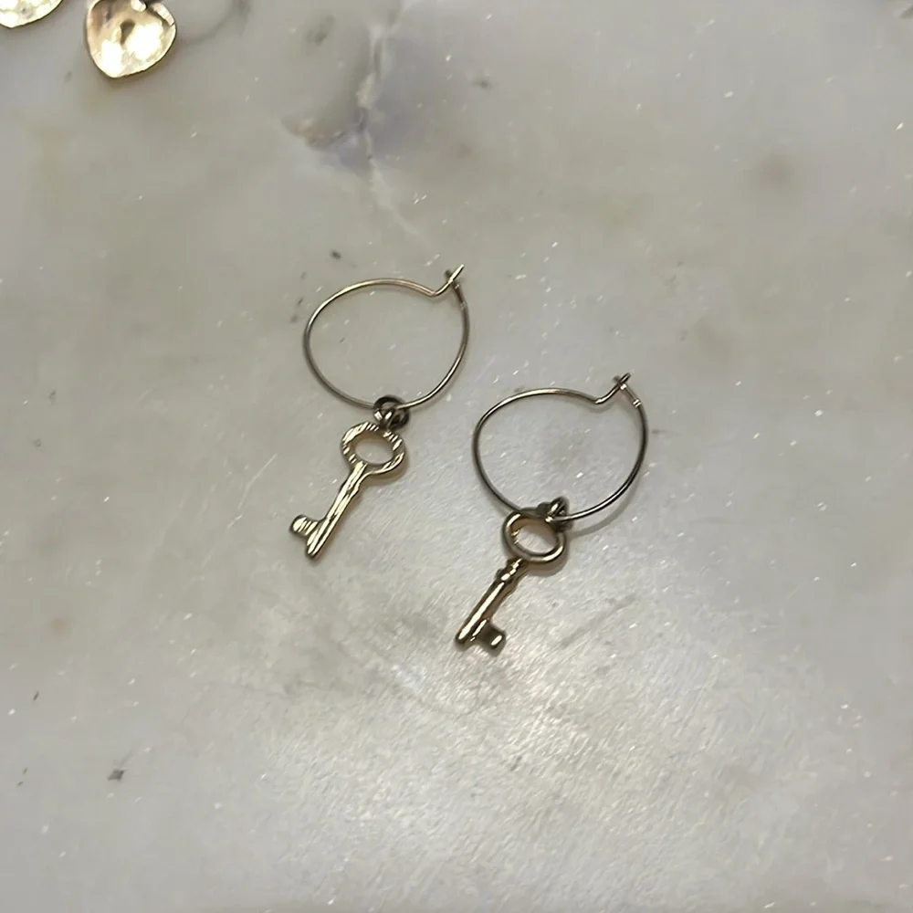 Charming Charlie gold tone four pairs of hoop Love, key and lock earrings bundle